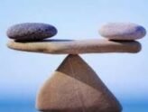 three rocks balanced on tip of another depicting importance of balance