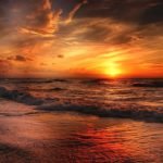 red skies at sunset at a beach