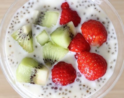 strawberries and kiwi in a bowl with dairy