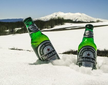 two heinekens immersed in snow