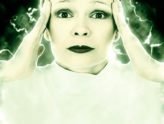 lady holding her temples to portray pain of migraines